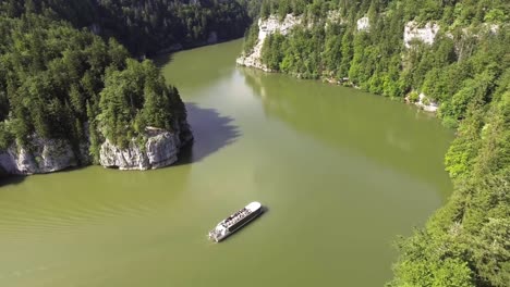 tourist boat on the natural river doubs in switzerland, lac de brenets and saut du doubs