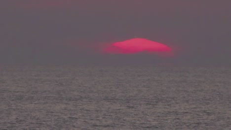 timelapse, a large sun sets in orange clouds that turn blue
