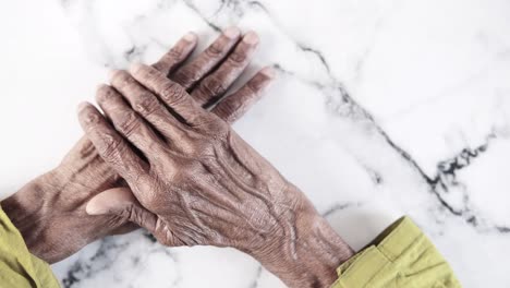 wrinkled hands of an elderly person