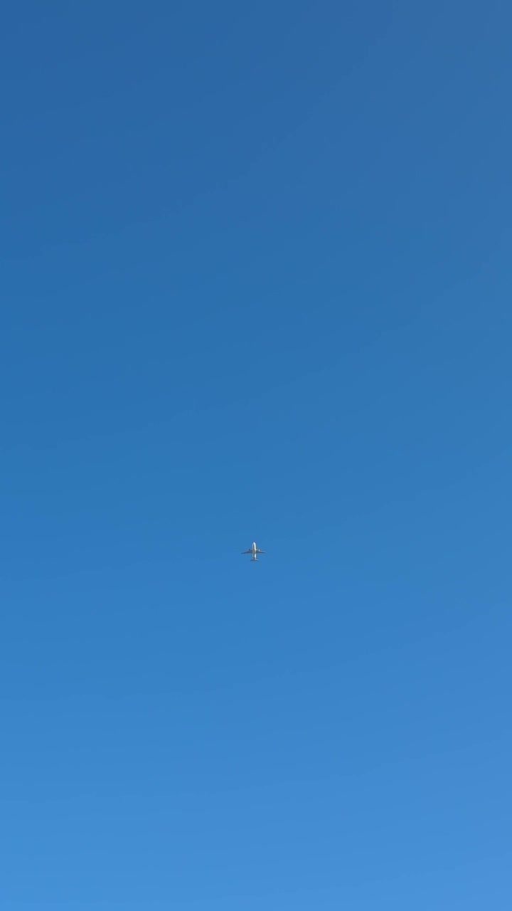 Aereo commerciale in volo in un cielo azzurro e limpido