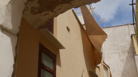 medium shot of a blanket hanging and swaying in the wind on a summer day in anacapri