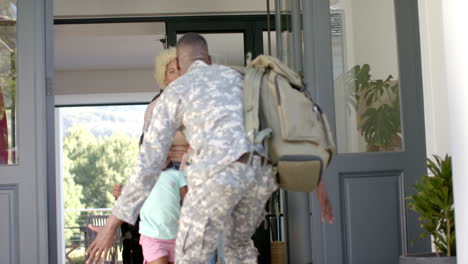 biracial family greets african american father returning from duty