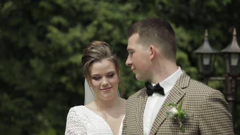 newlyweds. caucasian groom with bride walking in park. wedding couple. man and woman in love