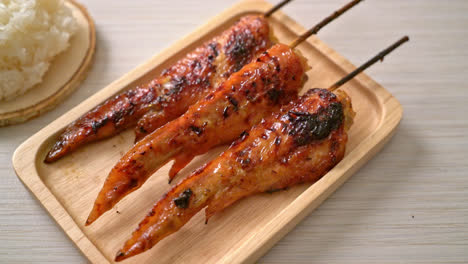 grilled or barbecue chicken wings skewer with sticky rice