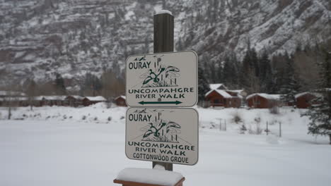 uncompahgre river walk signs in snowy winter landscape of ouray, colorado usa