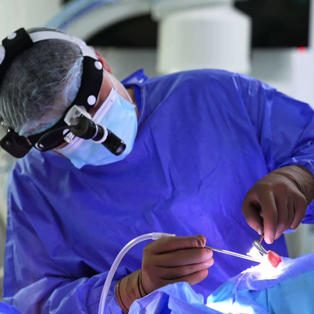 Surgeon using a diversity of instruments at nasal surgery. Assistant passing tools to a doctor