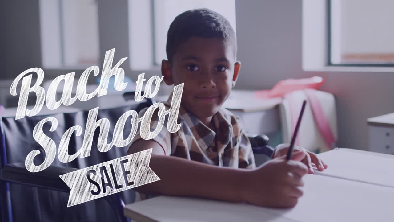 Animation of back to school sale text over smiling biracial schoolboy working at desk in class