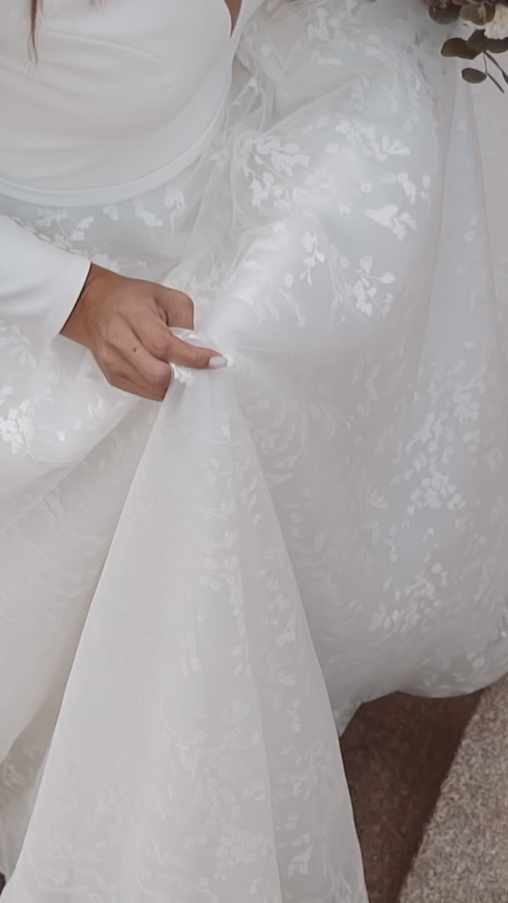 Graceful young woman bride wearing long white wedding dress and shoes goes up stairs on city street closeup slow motion. Wedding ceremony conducting