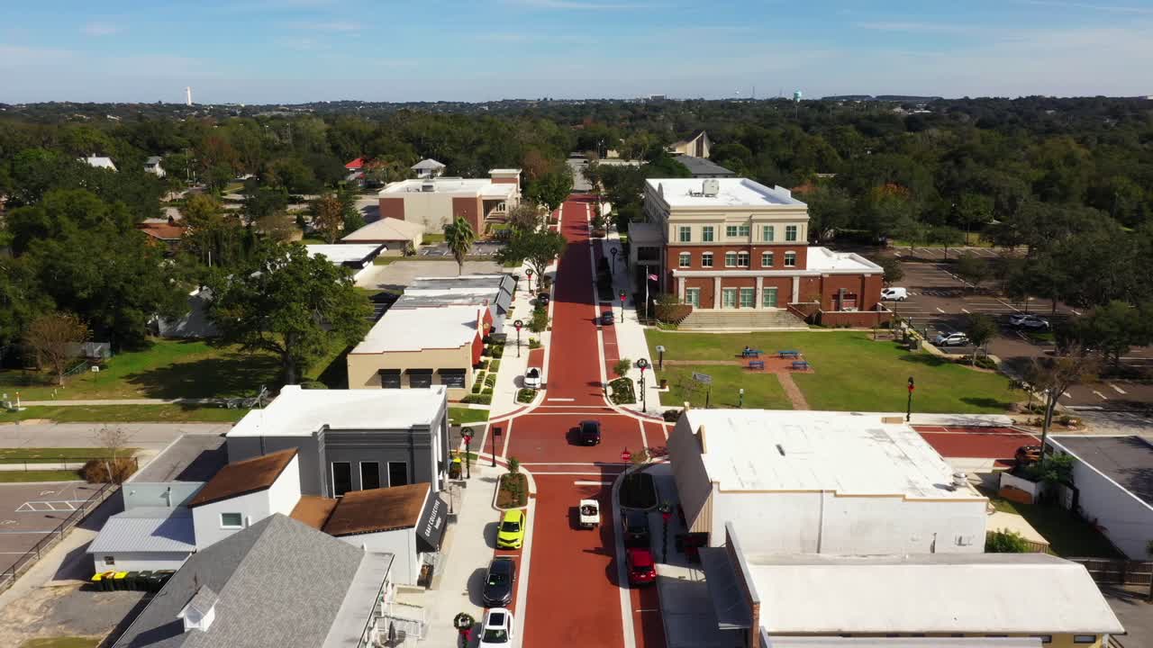 Bird's eye view above cars driving along historic downtown Clermont Florida main street
