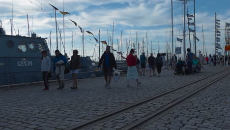 people and boats at a lively harbor