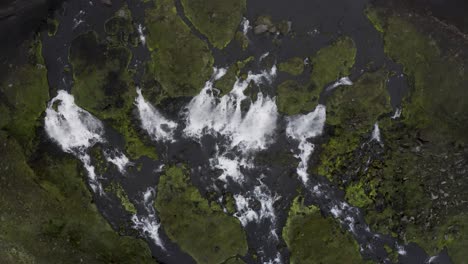 Aerial-top-down-shot-of-several-waterfalls-cascading-in-Iceland-Island-during-foggy-day