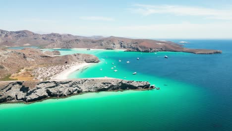 a turquoise bay in la paz, tecolandra, mexico with boats, aerial view