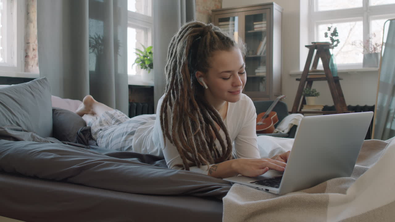 Woman Resting In Bed With Laptop