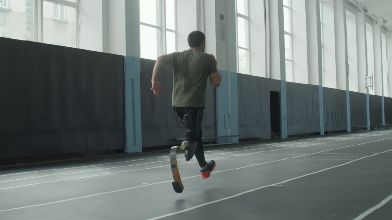 Professional Runner with Prosthetic Limb Training in Stadium