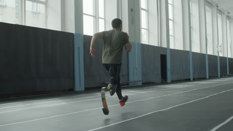 professional runner with prosthetic limb training in stadium