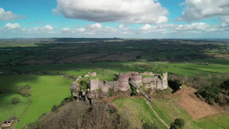 Beeston-Castle-medieval-historic-landmark-in-the-springtime-sun---aerial-drone-nearby-approach-showing-tourists---Cheshire,-England,-UK