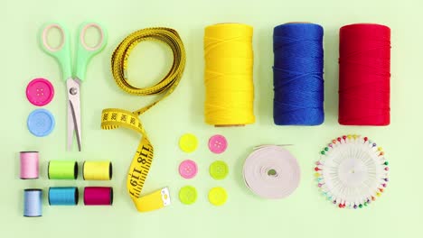 knitting and sewing items move on green theme. stop motion flat lay