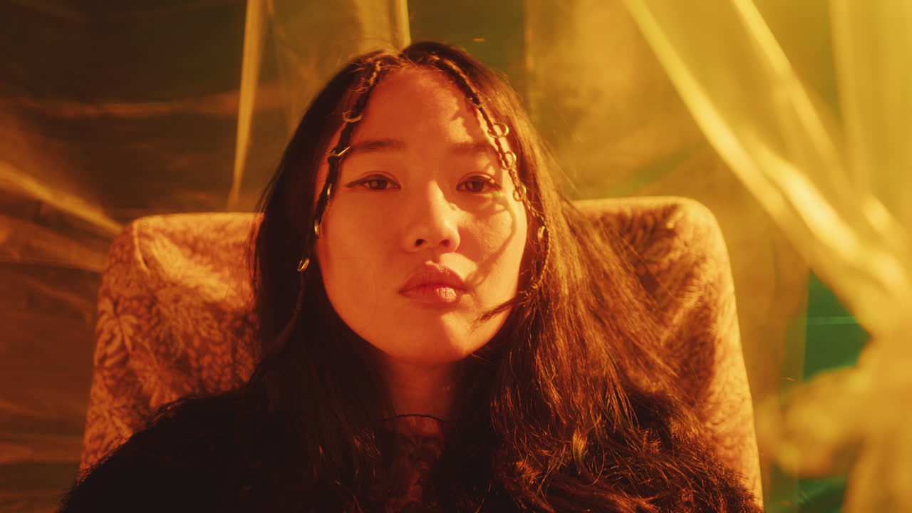 Portrait of Beautiful Asian Girl in Studio with Neon Light and Plastic Wrap