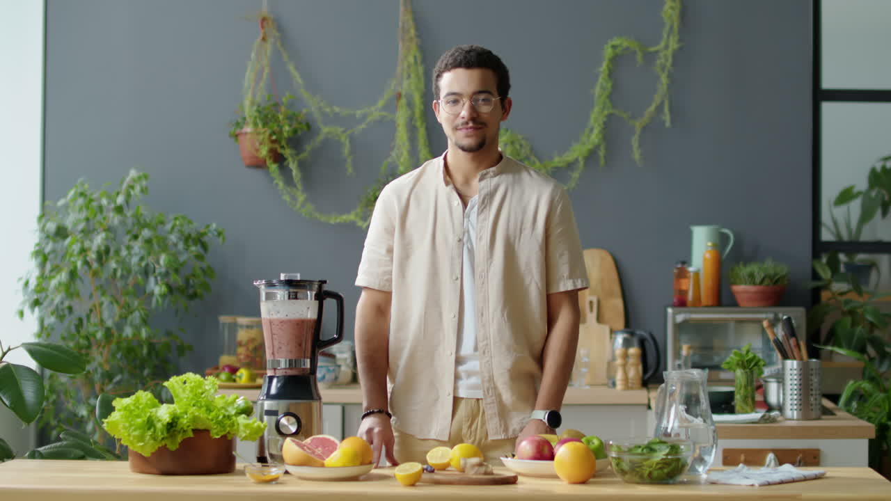Portrait of Vegan Man with Fresh Fruit and Smoothie in Blender