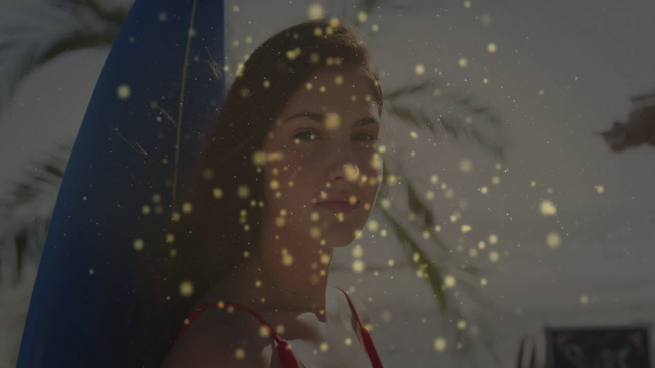 Woman leaning on surfboard at beach, showing golden sparkles and palm fronds for travel marketing