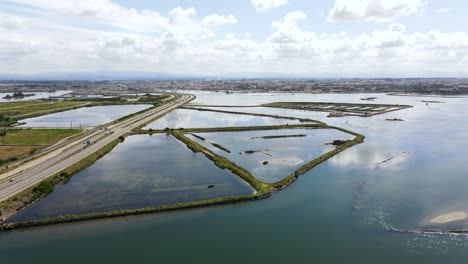 Incredible-Aerial-view-of-a-Highway-road-surrounded-by-river-channels-and-land-lines