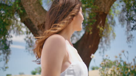 coquettish girl hold daisies bouquet walking garden closeup. happy lady spinning