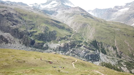 tilt up, cervin well-known mountain snowy peak in the summer, grass meadows on the summits, drone aerial view, nature landscape