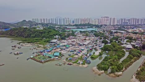 a dynamic ascending aerial footage of the fishing village in lau fau shan in the new territories of hong kong