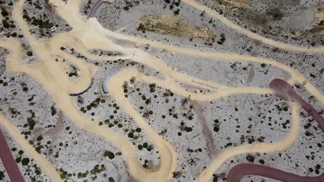 descending aerial view over mountain bike park withmultiple downhill trails, allara - perth