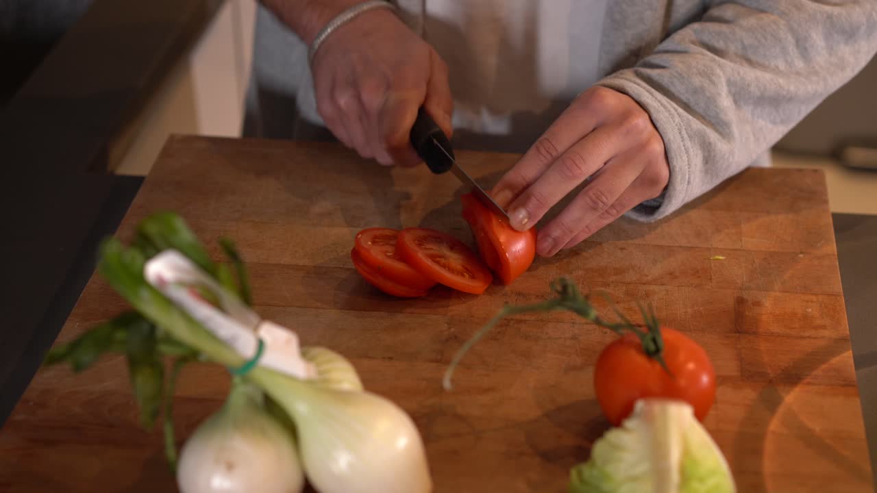 Preparing a fresh salad with tomatoes and onions