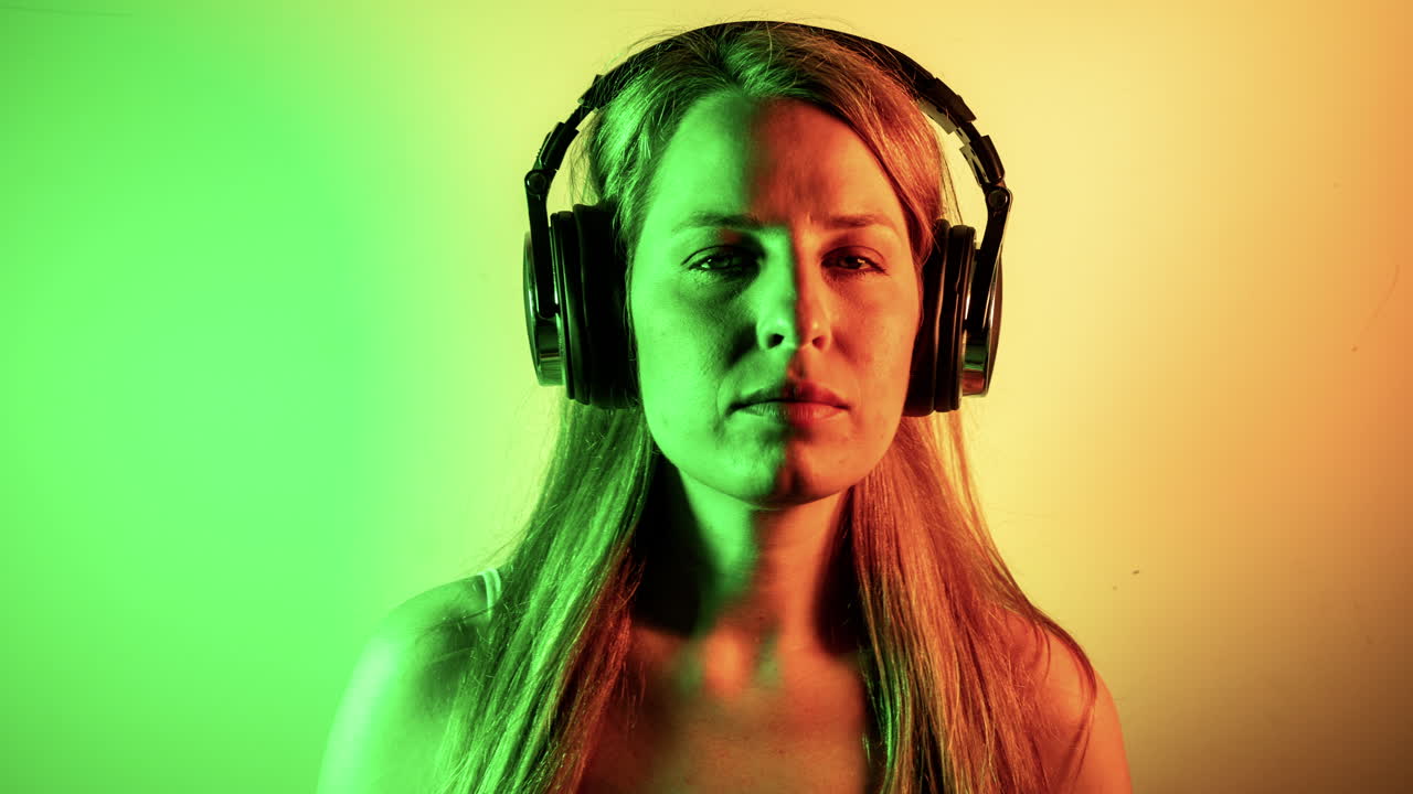 cool female dancer with changing retro headphones to listen to music