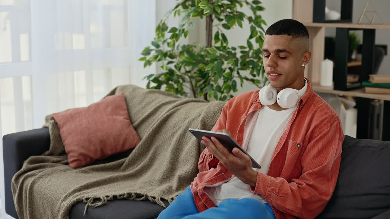 Young Man Using Digital Tablet at Home