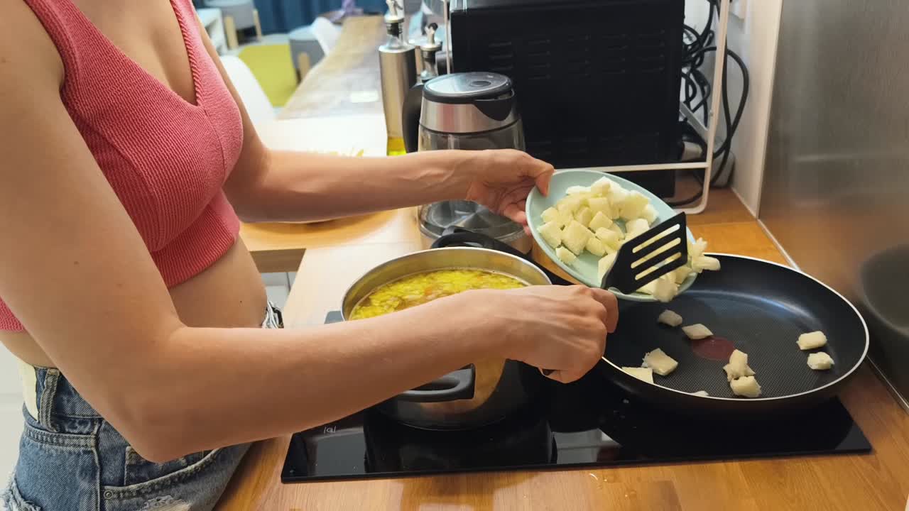 Woman cooking pasta and frying food in the kitchen