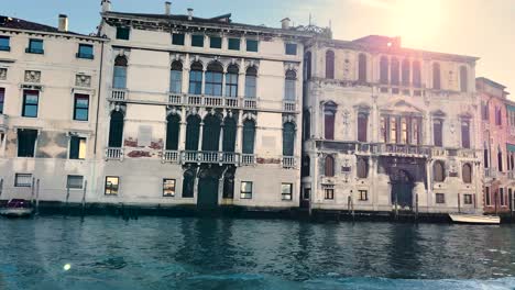 speedboat cruising by the grand canal during midday in venice, italy . - tracking shot