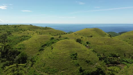 drone view of the rolling green hills known as teletubbies hill on nusa penida, bali, indonesia