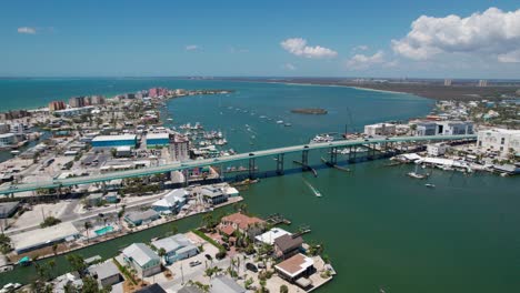 orbiting drone shot of the fort myers beach bridge in florida