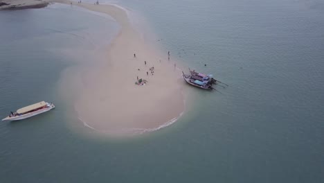 aerial view of tourists and boats on a private island in phuket, thailand - drone shot