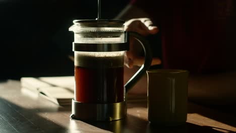 french press coffee brewing in harsh sunlight