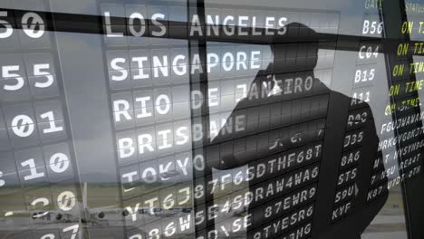 silueta de un hombre mirando por una ventana del aeropuerto