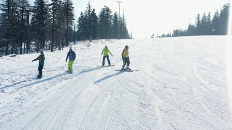 skiing and snowboarding on a sunny winter mountain slope