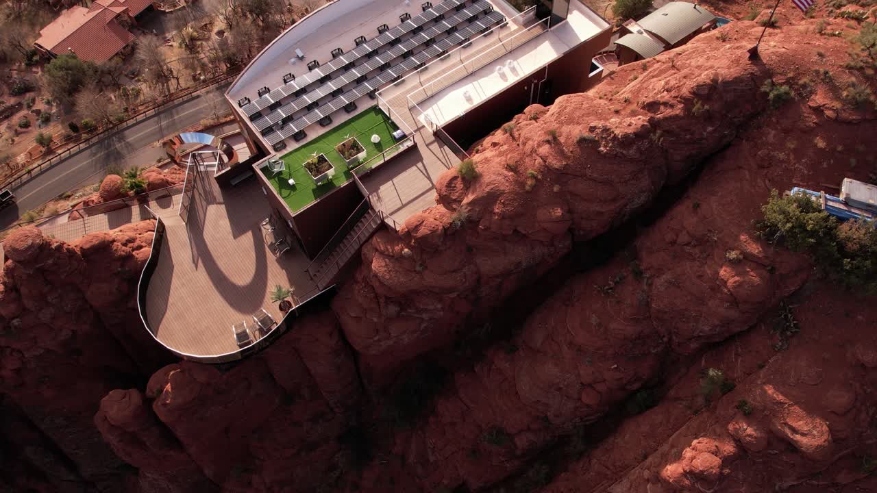 Aerial View of Modern Clifftop House With Solar Panels, Futuristic Villa Above Road in Sedona, Arizona USA