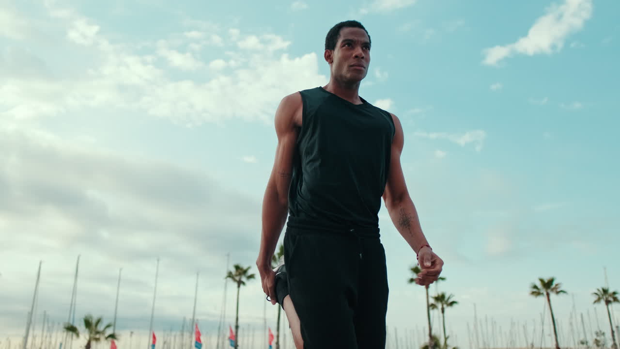Man Stretching Before a Run on the Beach
