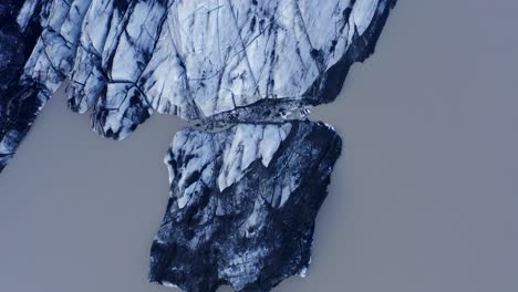 top-down view of the snowy solheimajokull glacier in iceland - famous tourist attraction - aerial drone