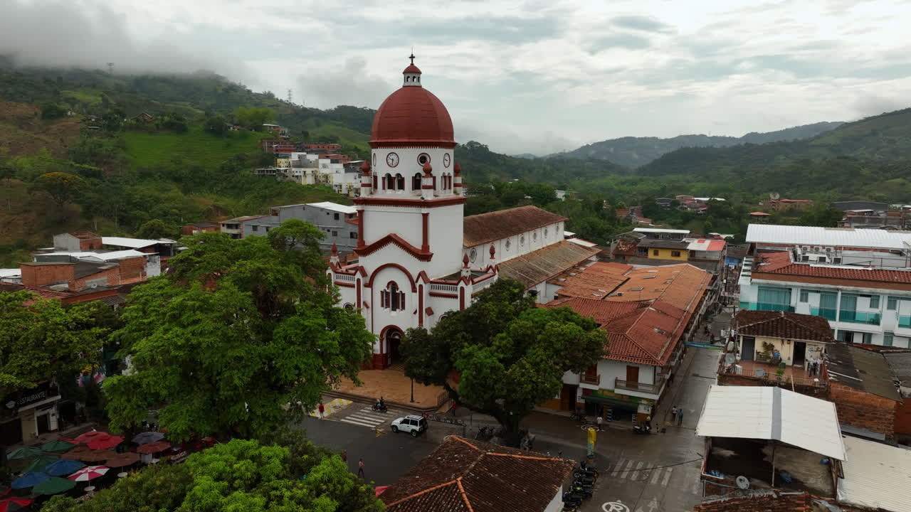 Aerial view rising in front of the St Raphael's Church in cloudy Antioquia, Colombia
