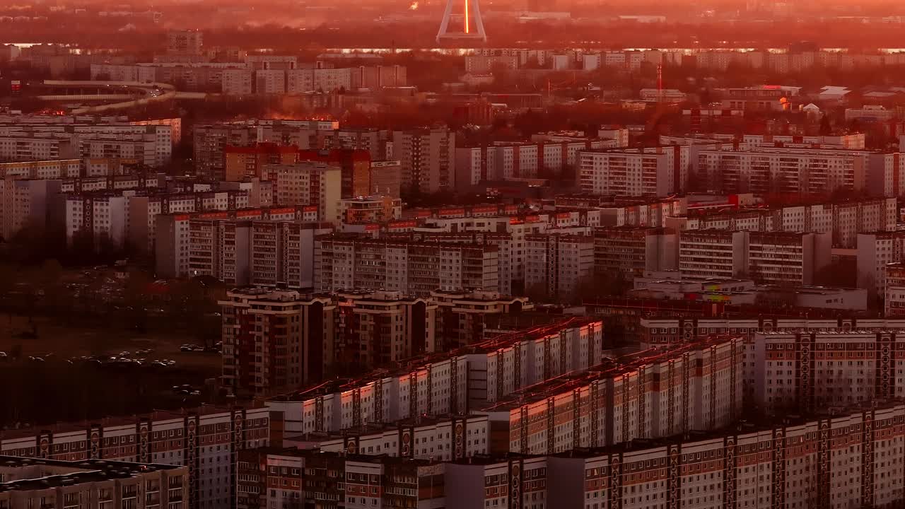 Golden hour glows over Plavnieki with Riga TV tower dominating distant skyline