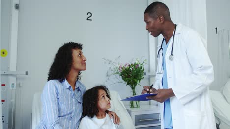 Front-view-of-African-american-male-doctor-doing-routing-check-up-in-the-ward-at-hospital-4k