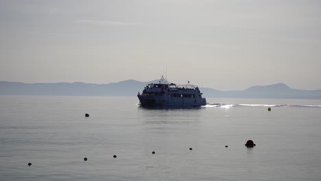 Catamaran-sailing-the-coast-of-majorca,-a-Balearic-Island-during-a-touristic-cruise