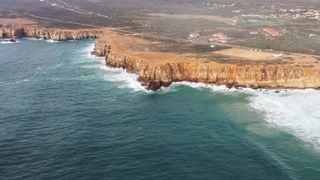 Praia-Do-Tonel-ocean-cliffs-in-Cape-Sagres-Portugal-during-sunset,-Aerial-circle-pan