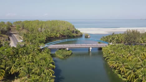 aerial view of soge bridge, the bridge located in pacitan district has a beautiful view of the beach and a large river surrounded by hills