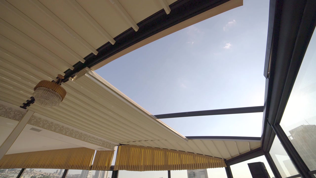 Retractable Roof Opening to Reveal Clear Blue Sky